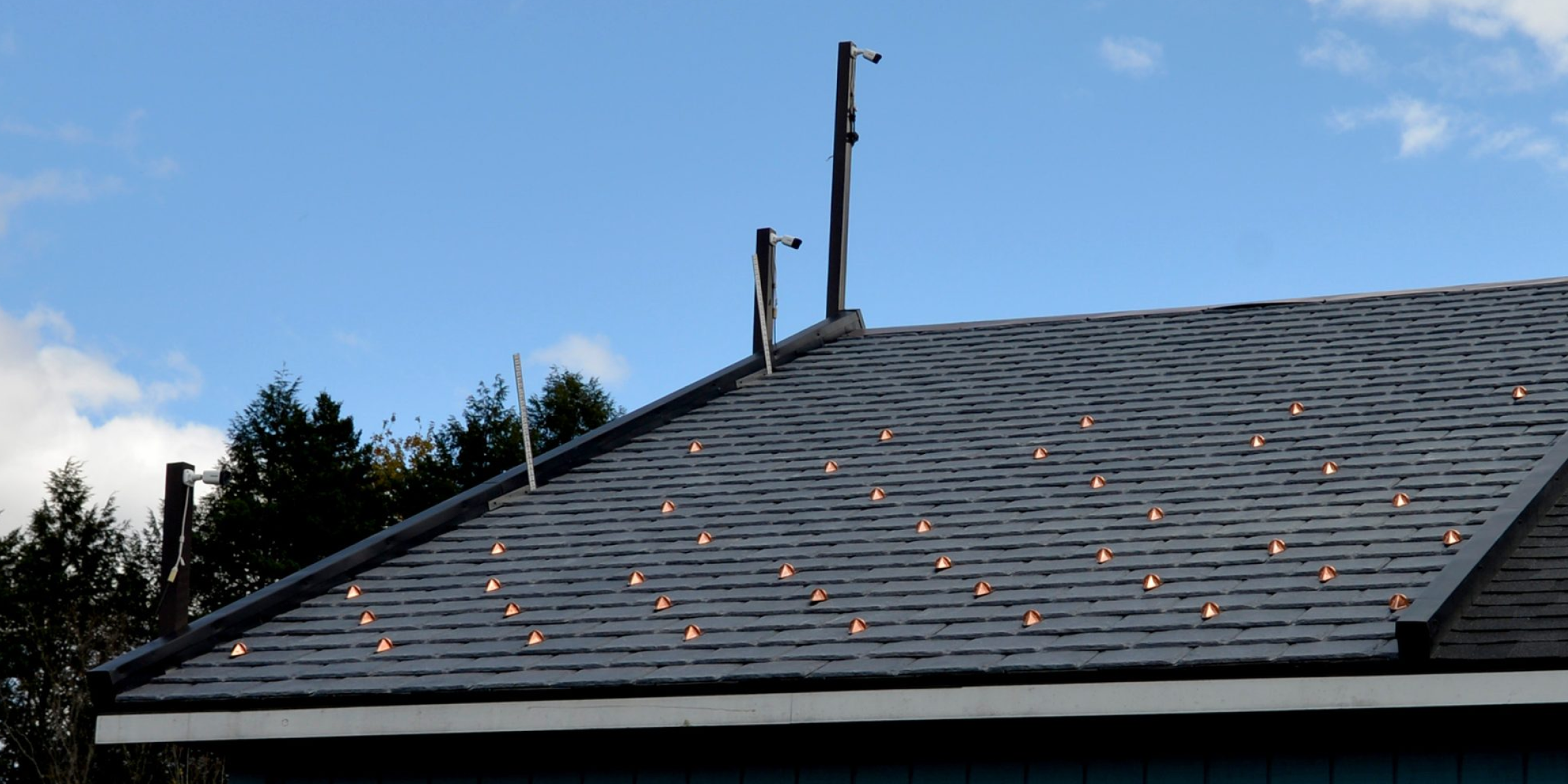 Half round pad-style snow guards for composite roofing materials.