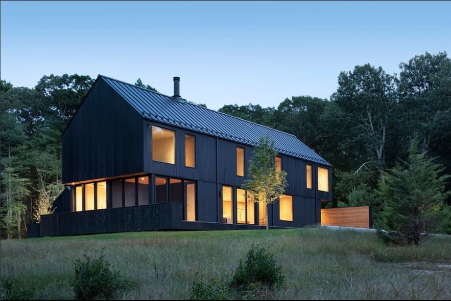 Residential property with standing seam metal roof featuring fence-style snow guards.