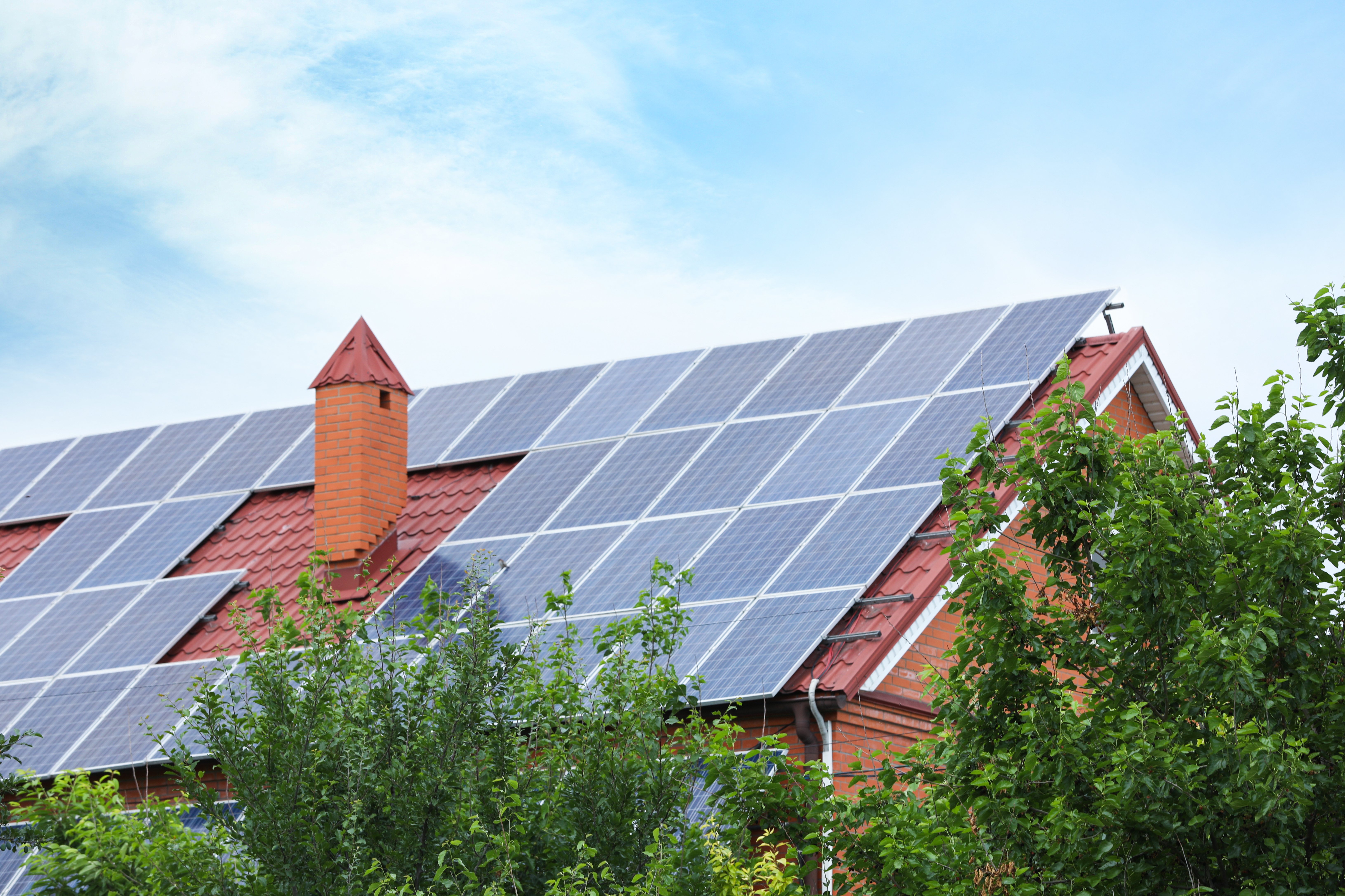 Solar panels with out solar snow guards on a red tile roof.